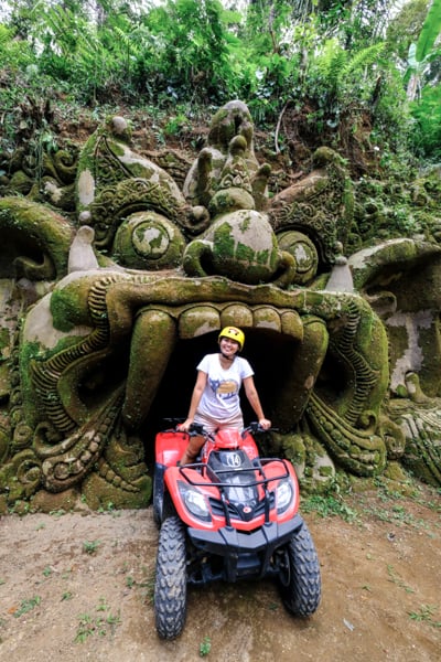 Girl riding an ATV at a barong demon cave in Ubud