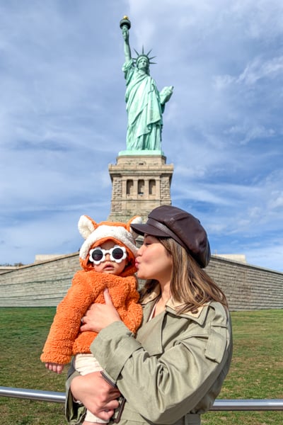 Posing with the Statue of Liberty in New York City