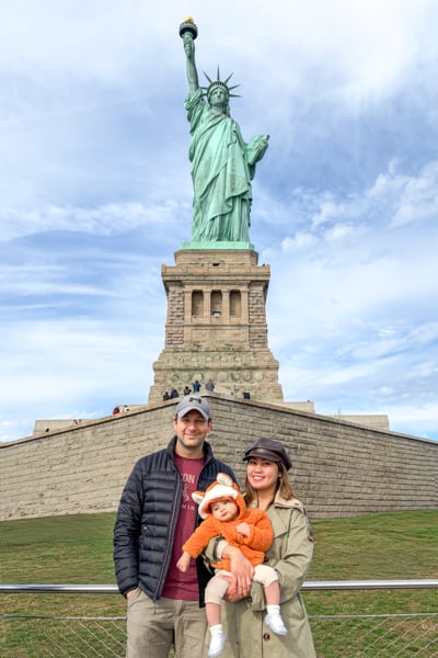 Posing with the Statue of Liberty in New York City