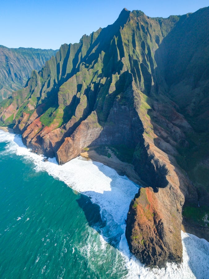 Doors off helicopter view of the Na Pali coast and Honopu beach in Kauai Hawaii